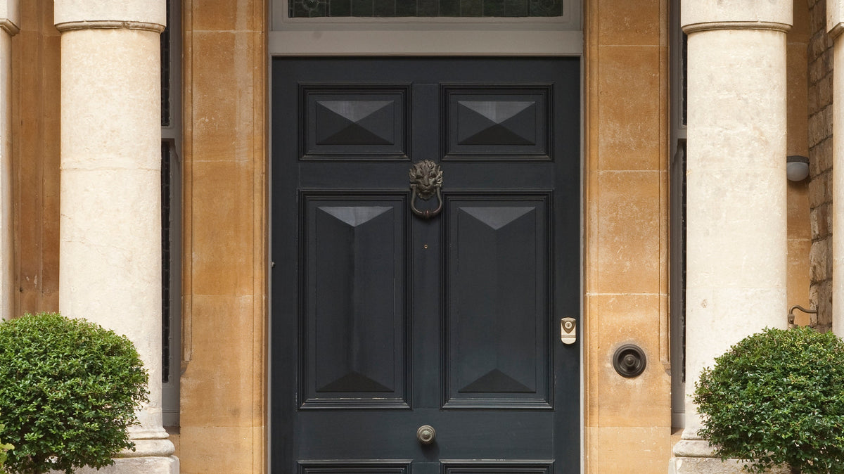 Panelled front door painted in Farrow & Ball Railings