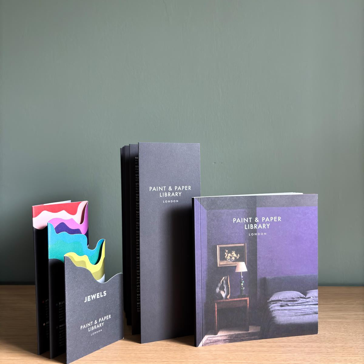 Paint & Paper Library colour cards displayed with premium paint brand samples