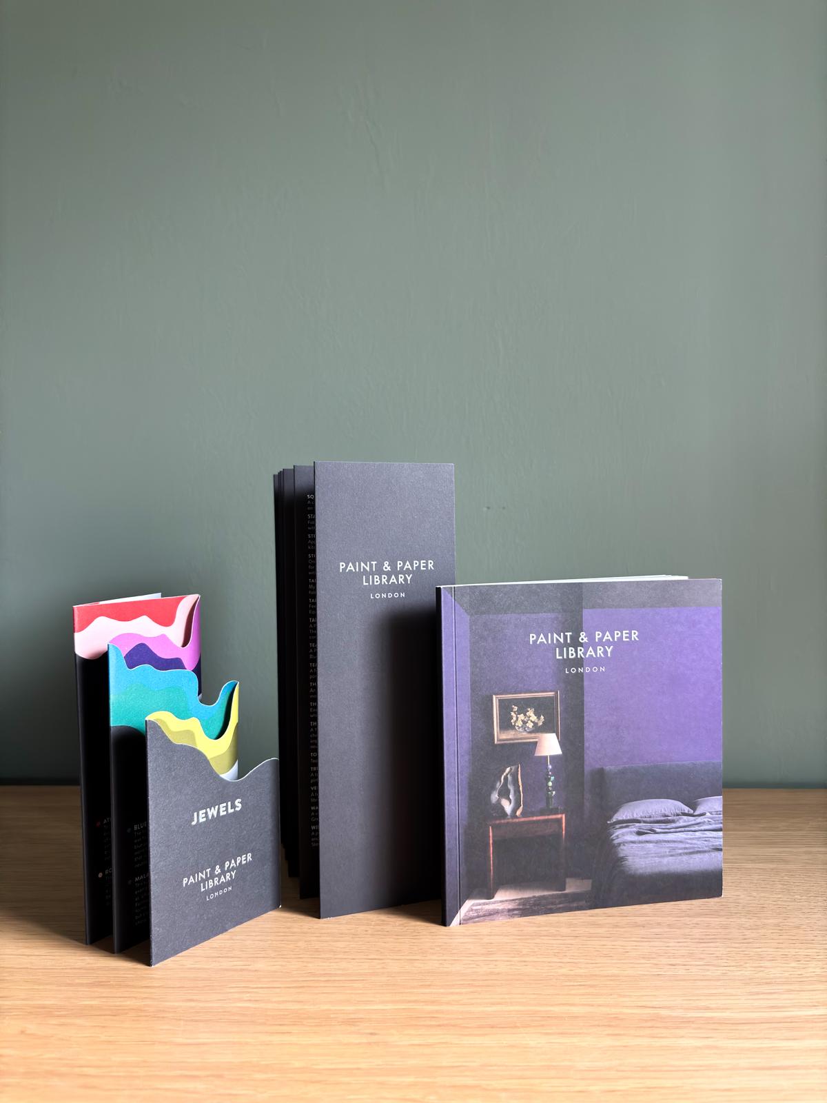 Paint & Paper Library colour cards displayed with premium paint brand samples