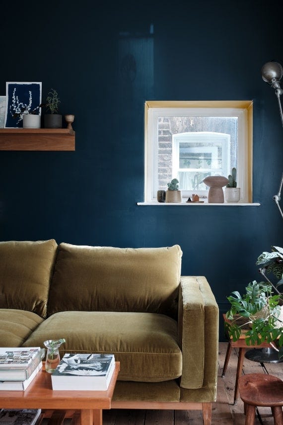 Cosy living room with deep blue walls painted in Farrow & Ball Hague Blue
