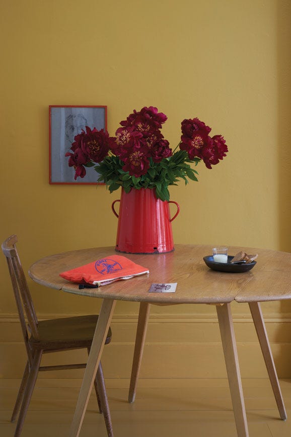 Dining room with walls painted in Farrow & Ball India Yellow