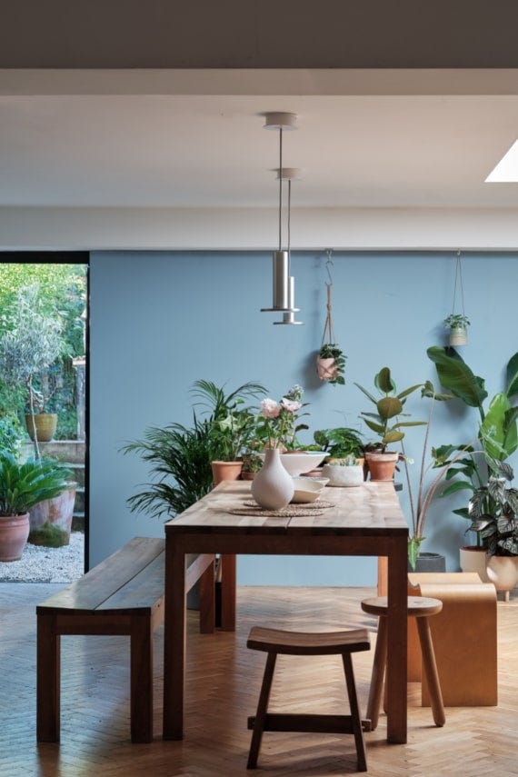 Dining room opening onto a garden with blue walls painted in Farrow & Ball Lulworth Blue