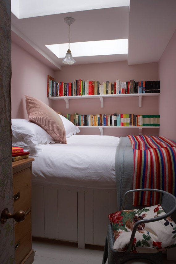 Cosy bedroom with bookshelves painted in Farrow & Ball Calamine
