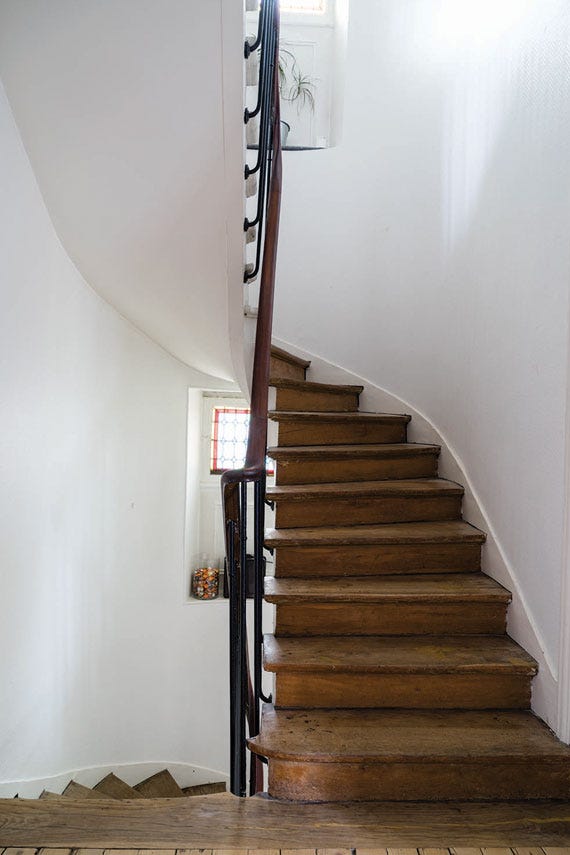 Hallway with a spiral staircase, walls painted in Farrow & Ball Pointing