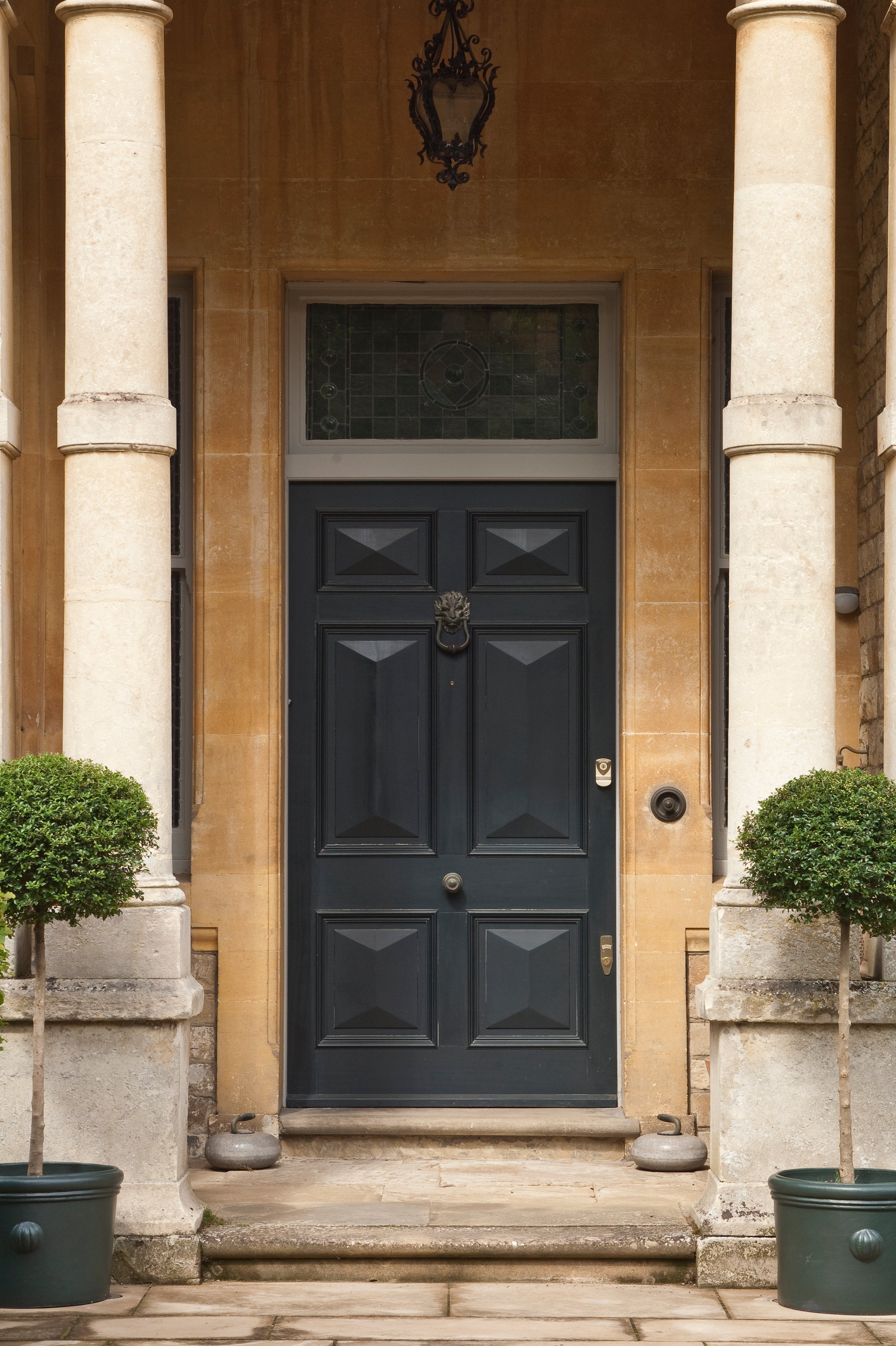 Panelled front door painted in Farrow & Ball Railings